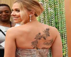 She has a big floral tattoo on her back. She has a big floral tattoo on her back.